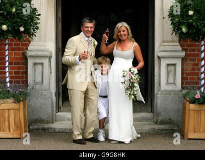 Russ Lindsay and Sally Meen with one of his sons Gabriel, 9, after the couple were married at the Great Fosters Hotel in Egham, Surrey. Stock Photo