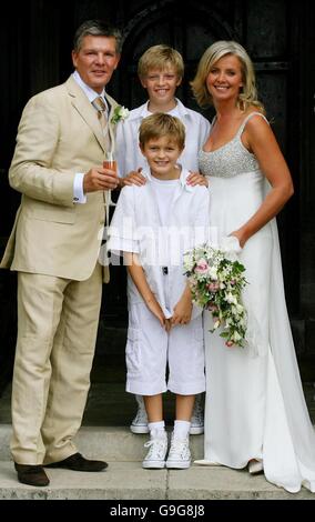 Russ Lindsay and Sally Meen with Mr Lindsay's sons Charlie, 12 (top), and Gabriel, 9 (top), after being married at the Great Fosters Hotel in Egham, Surrey. Stock Photo