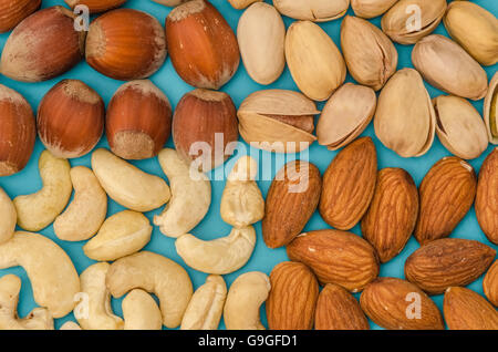 Group of different nuts isolated on blue Stock Photo