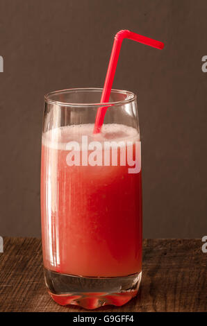 Glass with grapefruit juice on wooden table Stock Photo