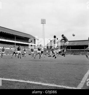 Arsenal's John Radford (r) and Terry Neill (second r) contest a header with Tottenham Hotspur's Mike England (behind Neill) Stock Photo