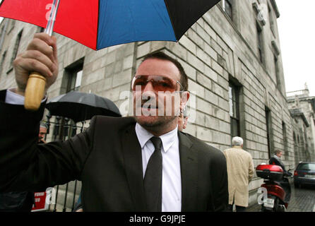 U2 frontman Bono leaves Dublin High Court after giving evidence in an appeal launched by the band's former stylist. Stock Photo