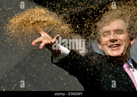 Chancellor Gordon Brown official opens the fifth Maggie's Cancer Caring Centre at Victoria Hospital in Kirkcaldy, by throwing seeds to the ground in the garden. Stock Photo