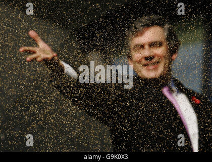 Chancellor Gordon Brown official opens the fifth Maggie's Cancer Caring Centre at Victoria Hospital in Kirkcaldy, by throwing seeds to the ground in the garden. Stock Photo