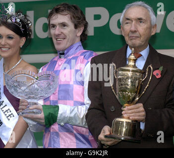 Owner Sir Robert Ogden (right) and jockey Tony McCoy celebrate after winning the Paddy Power Gold Cup Handicap Chase on Exotic Dancer at Cheltenham racecourse. Stock Photo