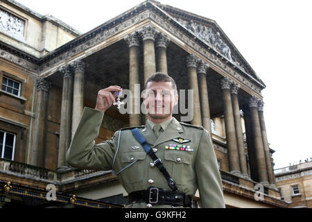 Major Scott Watkins of the Australian Army Aviation corps proudly displays his Distinguished Flying Cross at Buckingham Palace, in central London. Stock Photo