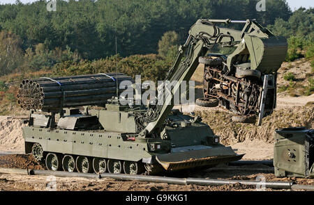 The Army's new heavily armoured engineer tank Trojan moves obstacles such as cars and concrete blocks at Bovington Military Training Area in Dorset. Stock Photo