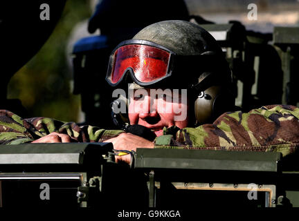 A soldier looks out from the Army's new heavily armoured engineer tank Trojan as it is unveiled at Bovington Military Training Area in Dorset. Stock Photo