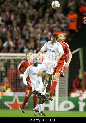 Liverpool's John Arne Riise (right) and PSV Eindhoven's Csaba Feher battle for the ball during the UEFA Champions League, Group C match against PSV Eindhoven at Anfield Stadium in Liverpool. Stock Photo