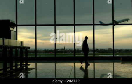 A worker walks past the panoramic window of one of the two satellites