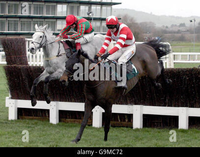 Cornish Rebel and jockey Ruby Walsh (right) jumps the last fence from Fork Lightning and jockey Robert Thornton and goes on to win The Unicoin Homes Handicap Steeple Chase at Cheltenham Racecourse. Stock Photo