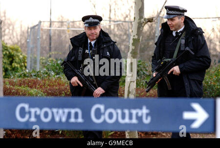 Armed police patrol the grounds of Woolwich Crown Court in south London, where six men went on trial today accused of plotting to murder people in alleged bombing bids. Stock Photo