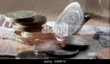 Cash and chequebooks illustrate the rising cost of living on the day interest rates were forecast for a further increase. Stock Photo