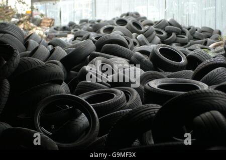 Urban decay stock: A huge pile of discarded car tyres on a walkway in Stratford, east London, on the edge of the 2012 Olympic development area. Stock Photo