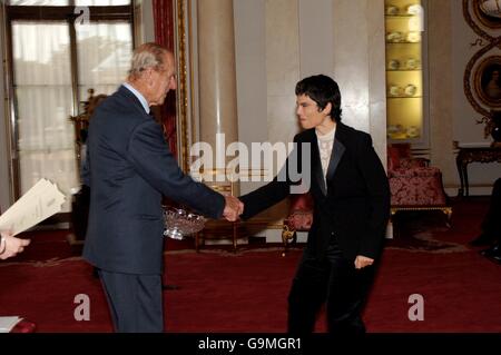 The Duke of Edinburgh shakes hands with Itziar Elorza as he presents the English Speaking Union President's Award to representatives of the Basque School Federation at Buckingham Palace, London. The federation received the award for their CD ROM for 9 to 10-year- olds called Space Search. Stock Photo