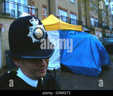 Police officers outside the Muswell Hill, North London home of former Russian spy Alexander Litvinenko who claimed to have been poisoned by his country's government and was killed by radioactive material in his body, it has been disclosed. Stock Photo