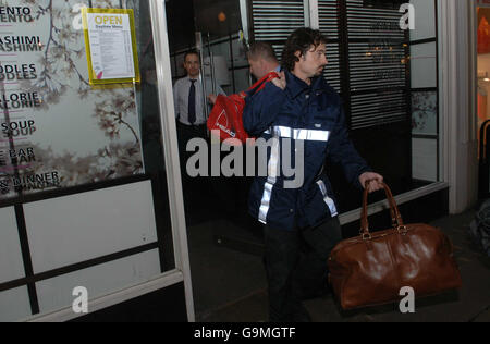 Men carrying bags leave Itsu sushi restaurant in Piccadilly where Alexander Litvinenko met with a Russian man on the day he believed he was poisoned. Stock Photo