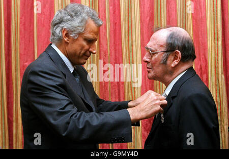 Nobel-winning British playwright Harold Pinter (right) is awarded the French Legion d'honneur by French Prime Minster Dominique de Villepin (left), at the French Embassy in London. Stock Photo