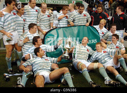 Rugby Union - Varsity match - Cambridge v Oxford - Twickenham. Cambridge celebrate with their trophy following victory over Oxford in the Varsity match at Twickenham, London. Stock Photo
