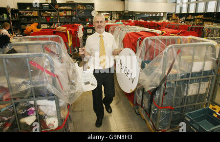 Centre Manager John McAleer with an electric guitar and a signed Queen Drum Skin, two of the 30,000 undeliverable parcels a week piling up at Royal Mail's national returns centre in Belfast. Stock Photo