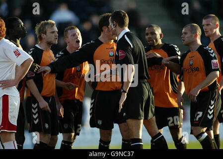 Barnet's players confront referee Andre Marriner after Dean Sinclair was sent off against Milton Keynes Dons during the Coca-Cola Football League Two match at the National Hockey Stadium, Milton Keynes. Stock Photo