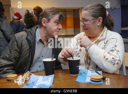 Two homeless people enjoy a cup of coffee at this year's Crisis shelter in east London. Stock Photo
