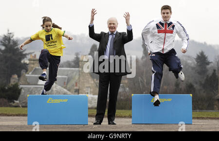 Sir Menzies Campbell (centre) with 110m hurdler Allan Scott (right) and 12-year-old Isabella Monteith at Bell Baxter High School in Fife, Scotland, where they visited the Grassroots Athletics roadshow. Stock Photo