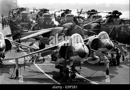 BAe Sea Harrier FRS.Mk.1's on the flight deck of the carrier HMS Hermes, with Westland Sea King helicopters behind, as she headed south for the Falklands. Stock Photo