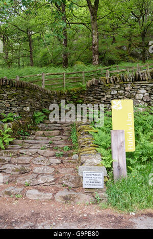 Signs by stone steps at start of Watkin path route through woodland to Mt Snowdon. Hafod y Llan, Nant Gwynant, Snowdonia, Wales, UK Stock Photo