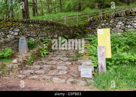 Signs by stone steps at start of Watkin path through woodland to Mt Snowdon. Hafod y Llan, Nant Gwynant, Snowdonia, Wales, UK Stock Photo