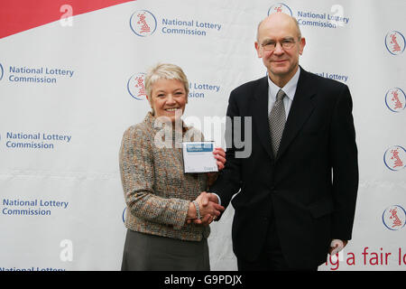 Chief Executive of Camelot Dianne Thompson (left) hands Camelot's bid for a third licence term to run the UK National Lottery to Robert Foster, Chairman of the Project Board of the National Lottery Commission (right), outside the National Gallery in central London. Stock Photo