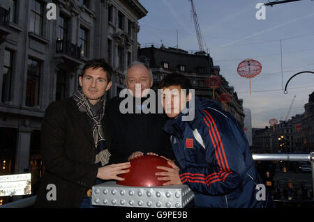 From left, Chelsea footballer Frank Lampard, Mayor of London Ken Livingstone and Chinese Olympic Team footballer Wang Dalei turn on the Chinese Lanterns in Oxford Circus, Central London, to celebrate Chinese new year. Stock Photo