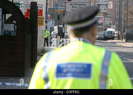 Scene of Crime Officers and forensics investigate the scene where a man was shot dead in the early hours of this morning on Homerton High Street in Hackney, east London. Stock Photo