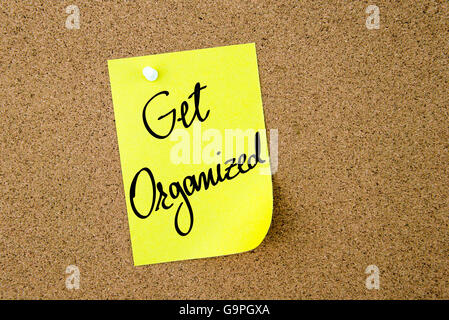 Get Organized written on yellow paper note pinned on cork board with white thumbtacks, copy space available Stock Photo