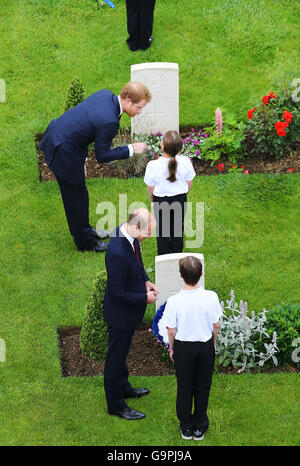 Prince Harry (top left) and the Duke of Cambridge speak to young people after they laid wreaths during a service to mark the 100th anniversary of the start of the battle of the Somme at the Commonwealth War Graves Commission Memorial in Thiepval, France, where 70,000 British and Commonwealth soldiers with no known grave are commemorated. Stock Photo