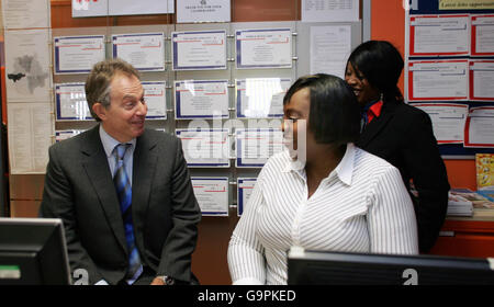 Britain's Prime Minister Tony Blair (left) talks to single mother Sandra Marshall (centre) during a visit to a branch of the job centre Reed in Partnership, in Walworth, London. Stock Photo