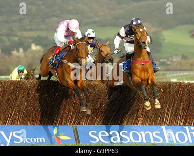 Voy Por Ustedes ridden by Robert Thornton (l) takes the last fence on his way to victory in the Seasons Holidays Queen Mother Champion Chase (Grade 1) Stock Photo