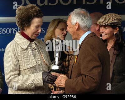 Her Royal Highness Princess Anne presents the trophy to owner Sir Robert Ogden for winning with Voy Por Ustedes in the Seasons Holidays Queen Mother Champion Chase (Grade 1) Stock Photo