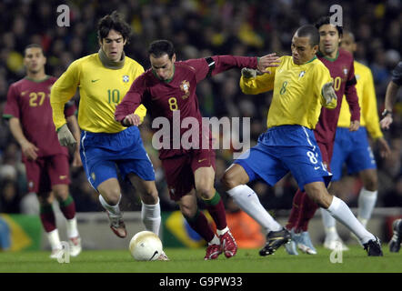 Portugal's Petit (centre) in action with Brazil's Kaka (left) and Gilberto Silva during a friendly international at the Emirates Stadium, London. Stock Photo