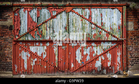 A rusty old sliding industrial door. Stock Photo