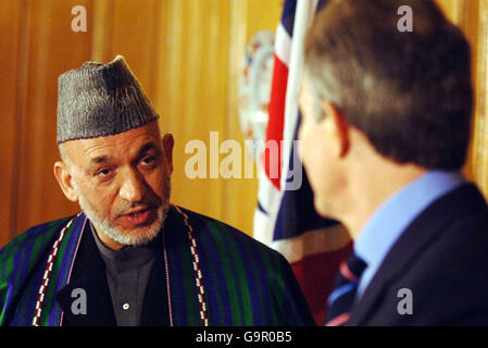 The Prime Minister Tony Blair (right) listens to President of Afghanistan Hamid Karzai during a press conference at number 10 Downing Street. Stock Photo