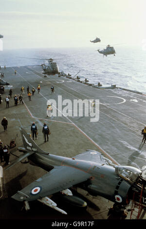 Sea King helicopters landing on the flight deck of HMS Hermes, the flag Ship of the British Task force on route to the Falkland Islands. Stock Photo