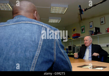 Saturday February 24, 2007. Home Secretary John Reid speaks with Colin Lambert wile visiting ex-prisoners at the St. Giles Trust in Camberwell Green in South London. Stock Photo