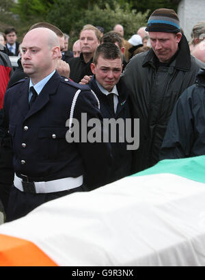 Niall Liston, the son of volunteer firefighter Mike Liston watches his coffin leave St Senan's Church, Foynes. Stock Photo