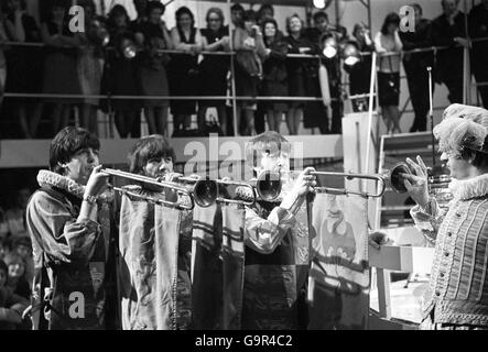 The Beatles - left to right Paul McCartney, George Harrison and John Lennon at Rediffusion's Wembley Studio rehearsing again for 'Around the Beatles', the first British television show built around the group. Stock Photo