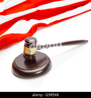 Close up shot of a wooden judge gavel near flag of Unites States of America Stock Photo