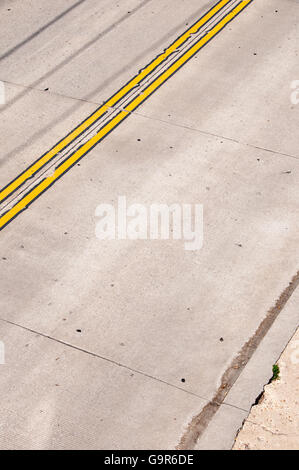 Yellow lines run parallel to the street Stock Photo