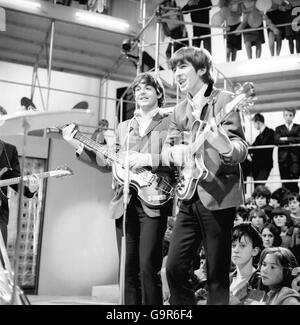 The Beatles - left to right Paul McCartney, George Harrison and Paul McCartney at Rediffusion's Wembley Studio rehearsing for 'Around the Beatles', the first British television show built around the group. Stock Photo