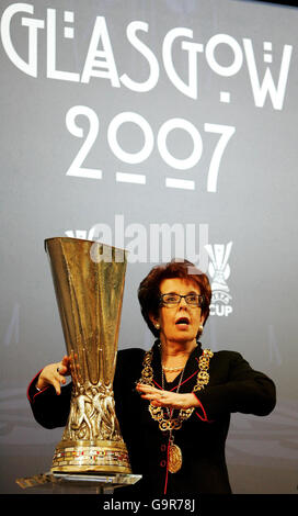 Glasgow Provost Liz Cameron gets her hands on the Uefa Cup during the UEFA Cup Handover ceremony and Final Phase Draw at the historic Old Fruitmarket, City Halls, Glasgow. Stock Photo