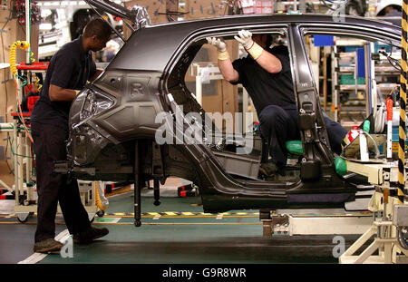 Production workers on the assembly line of the new Toyota Auris at the Toyota plant at Burnston, Derbyshire, during a visit by Britain's Chancellor Gordon Brown. Stock Photo